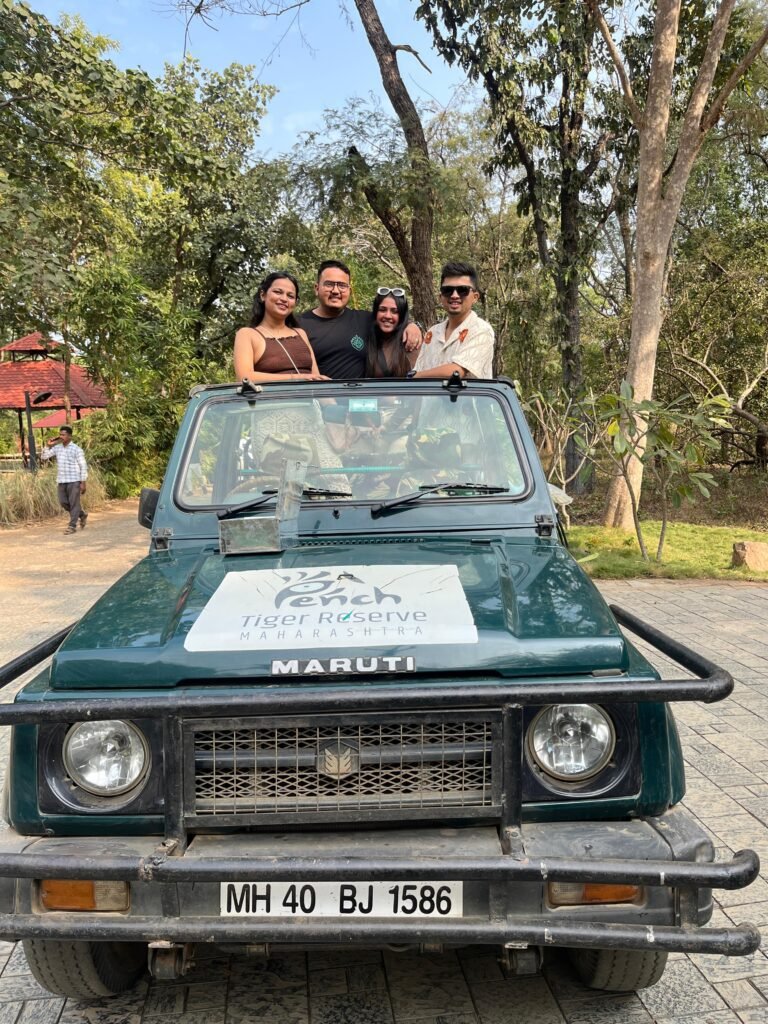 Safari Lab guests seated in an open safari vehicle in Pench